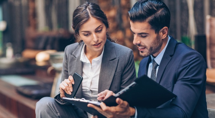 Two financial advisors reviewing top target markets for their firm.